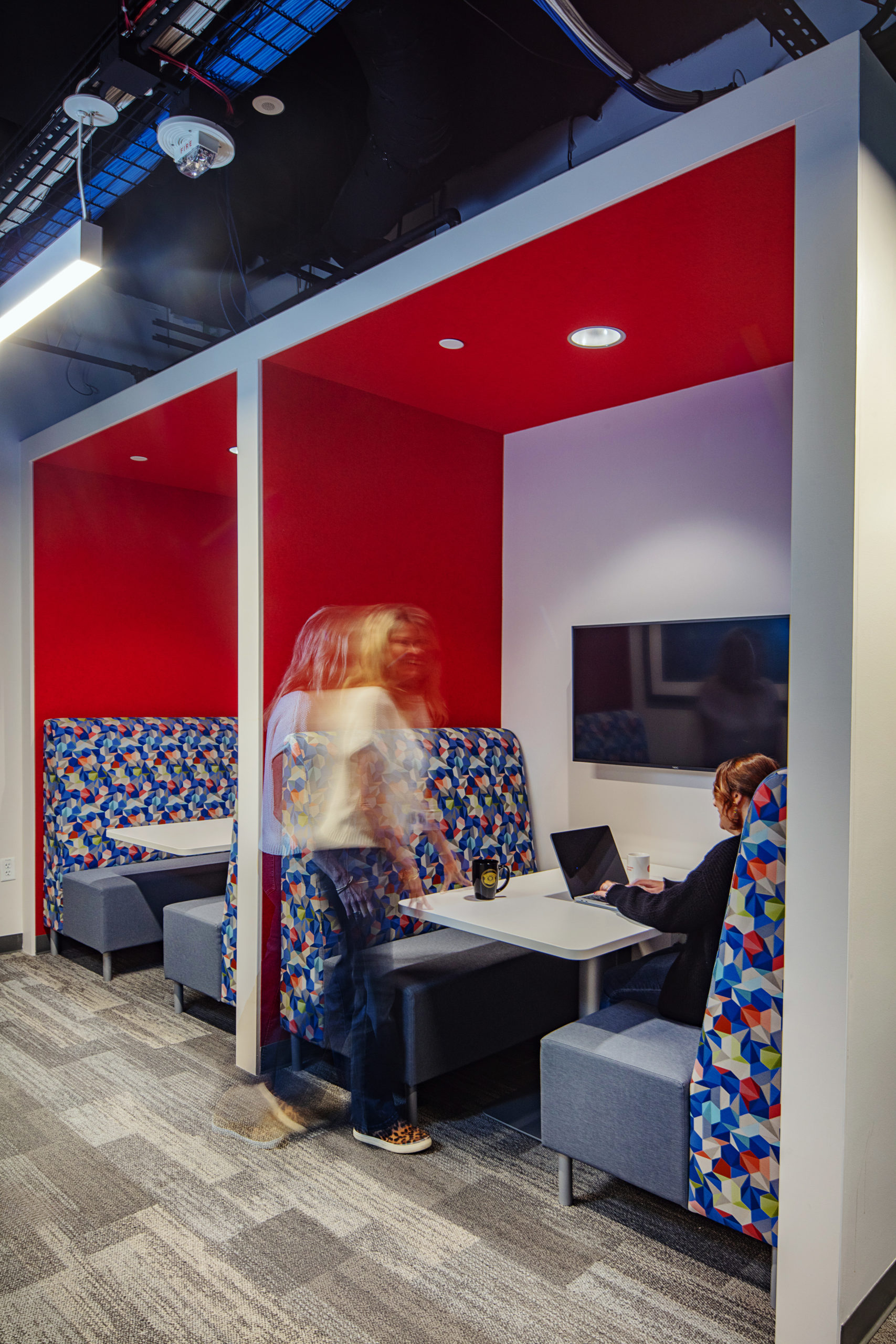 booth-area-with-tv-and-red-walls