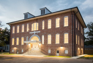 building at dusk with lights on. 2 story building